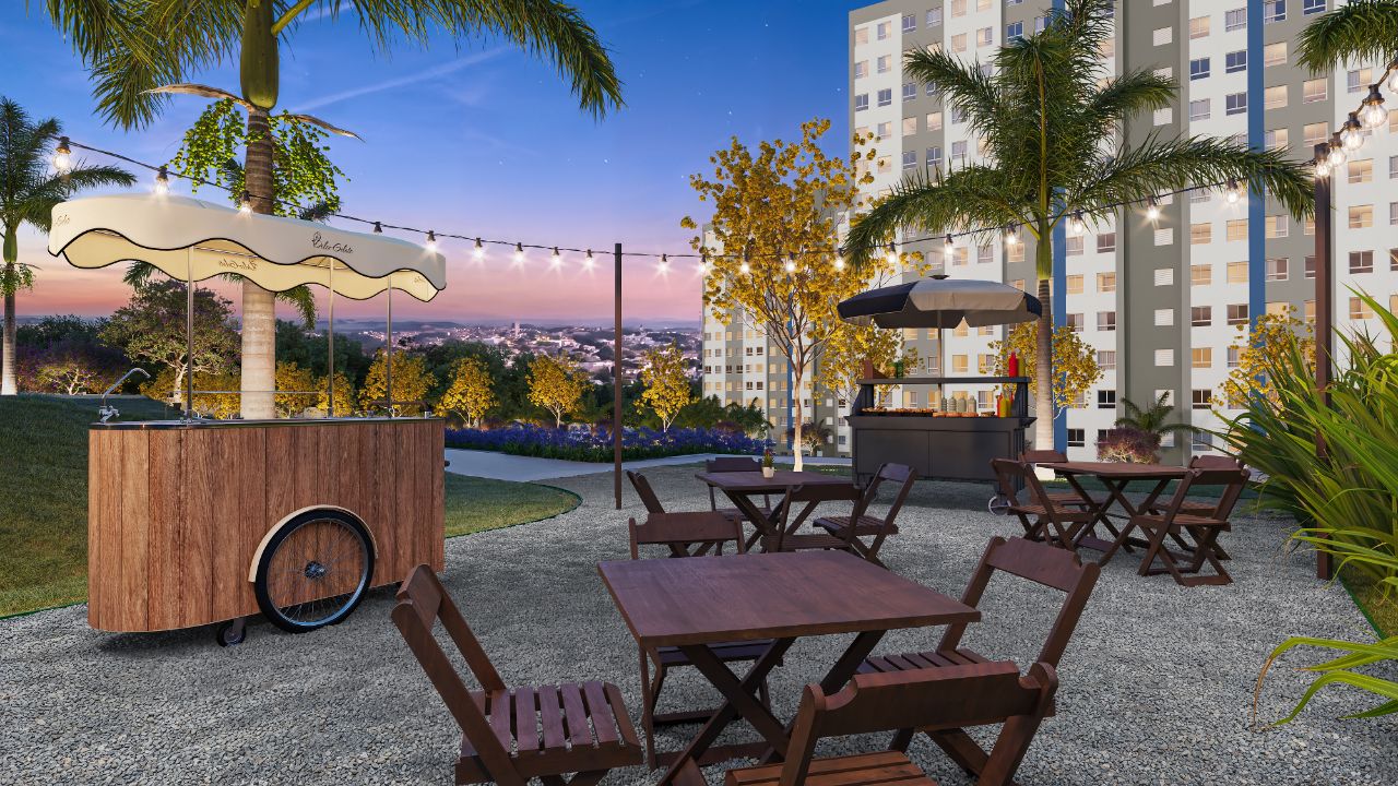 Praça de eventos com mesas, iluminação pendente e vista para as torres